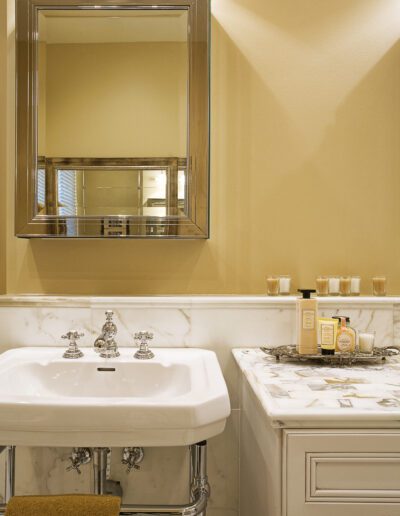 Elegant bathroom interior with marble countertop and chrome fixtures.